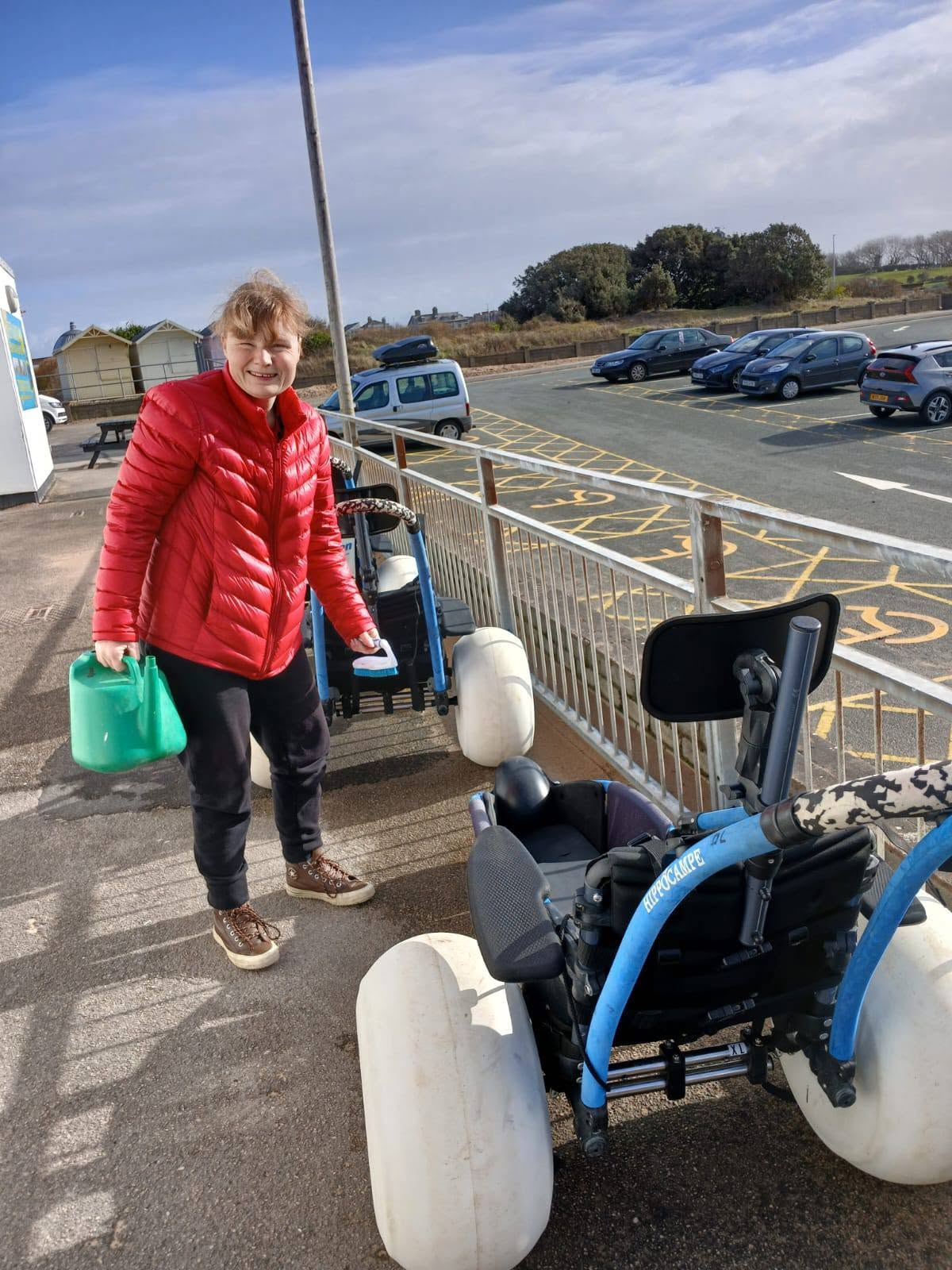 Volunteer with a watering can and brush cleaning Hippocampe chairs after use